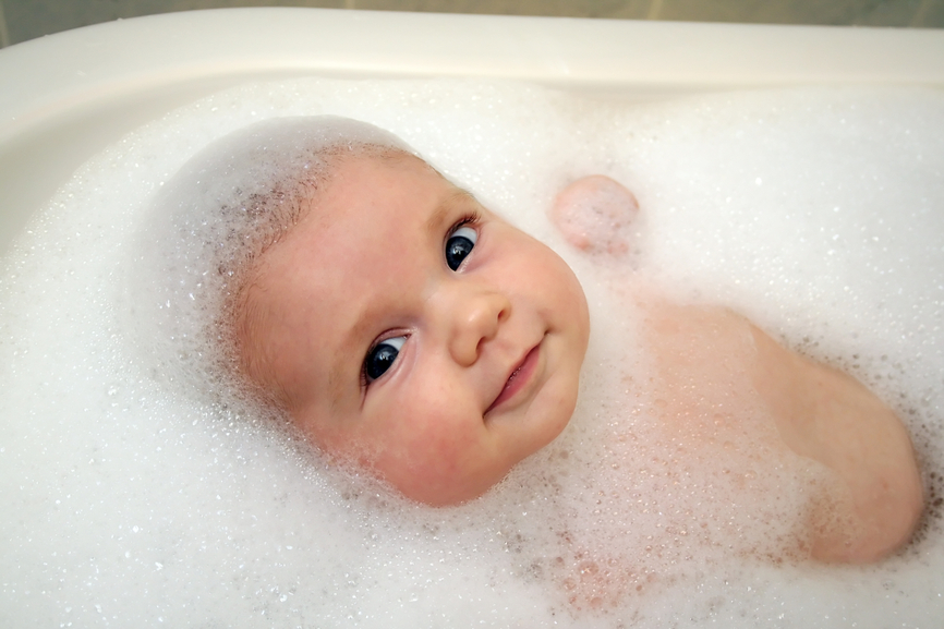 baby surrounded by soap bubbles